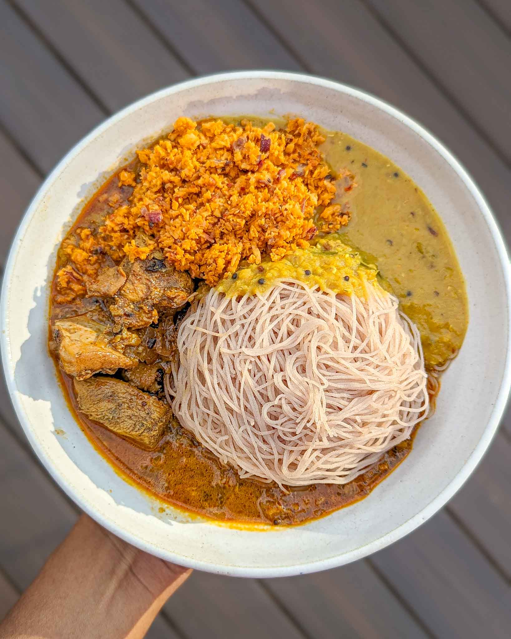 Coconut sambol with stringhoppers, chicken curry and red lentil curry